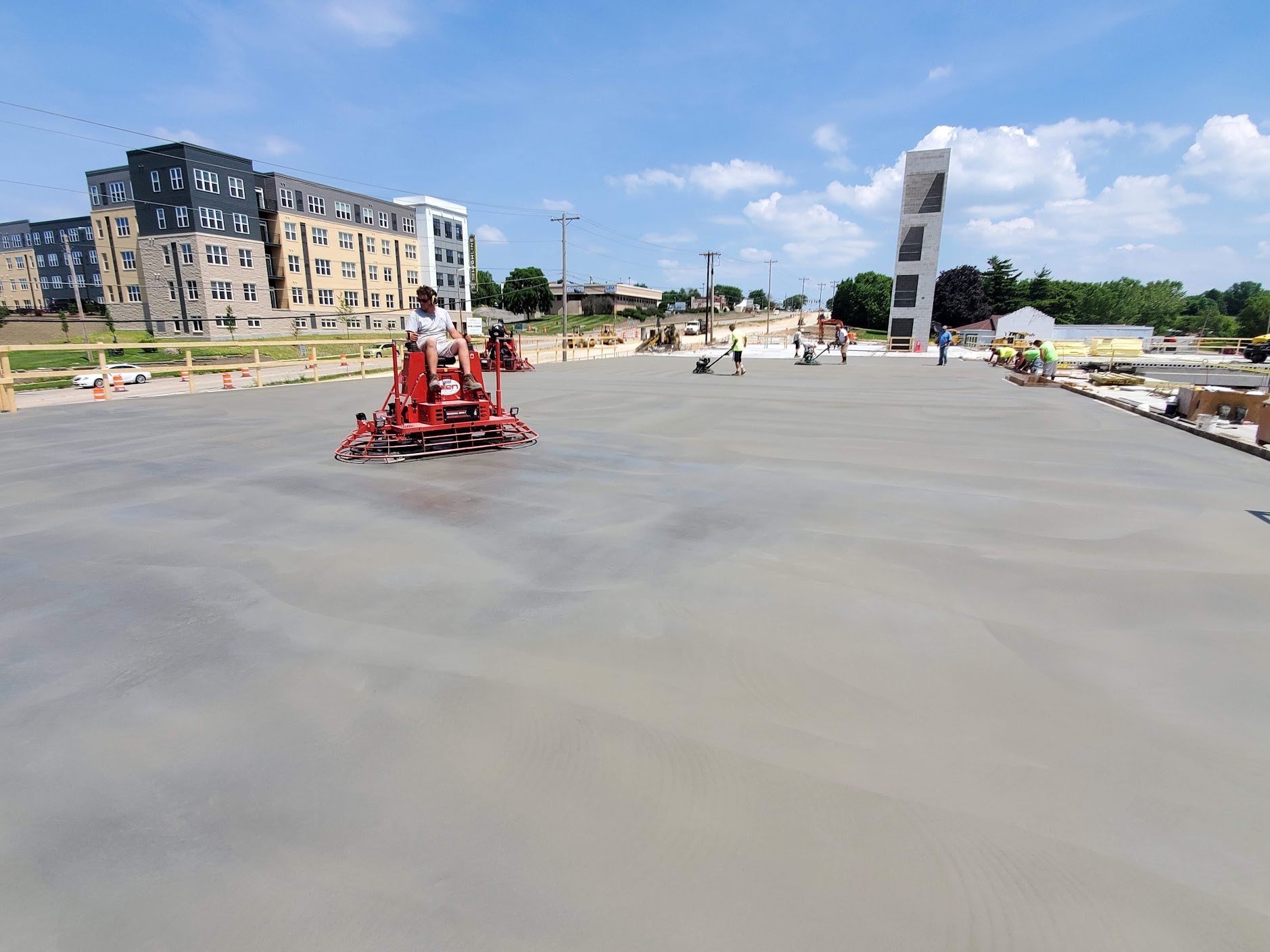 Concrete finishing with ride-on trowel on a construction site